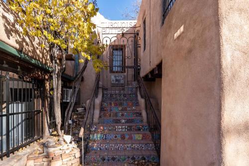 an alley with stairs leading up to a building at Casita Mariposa in Santa Fe