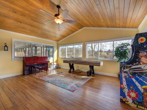a living room with a ceiling fan and a piano at Sunrise Cove in Dandridge