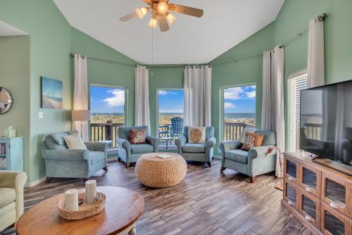a living room with a flat screen tv and furniture at Crandalls Cottage in Port Aransas