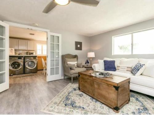 a living room with a white couch and a table at Cape Cod Cottage in Port Aransas