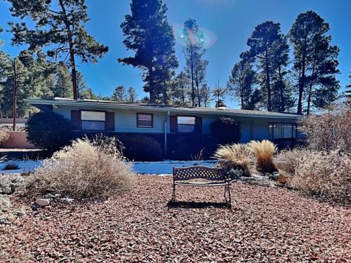 a house with a bench in front of it at The Crows Nest in Ruidoso