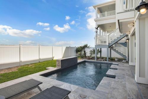 a swimming pool in the backyard of a house at Itll Do in Padre Island