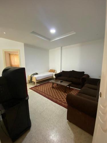 a living room with two couches and a tv at Raies in Akouda