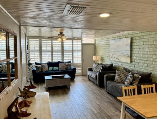 a living room with a couch and a table at Pearl Marlin in Port Aransas