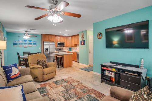 a living room with a couch and a dining room at Pawsitively Paradise in Mustang Beach