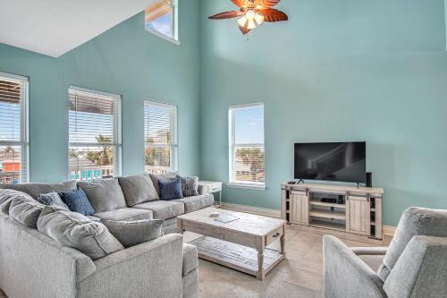 a living room with a couch and a tv at Sandbar in Port Aransas