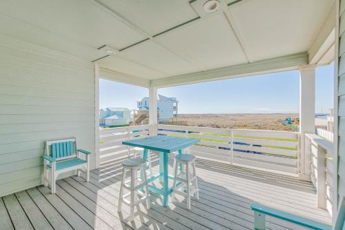 a porch with a blue table and two chairs at Postcard from Paradise in Padre Island