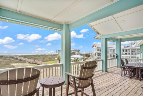 a porch with chairs and a table with a view of the ocean at Beach-A-Holic in Padre Island