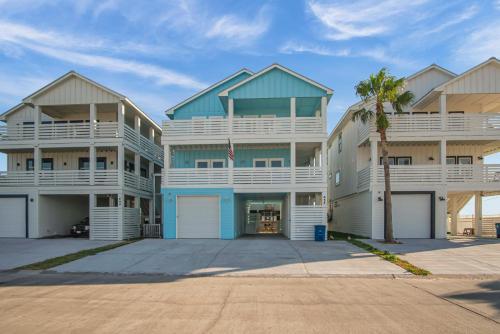 a large apartment building with white and blue at Ocean Spirit in Port Aransas