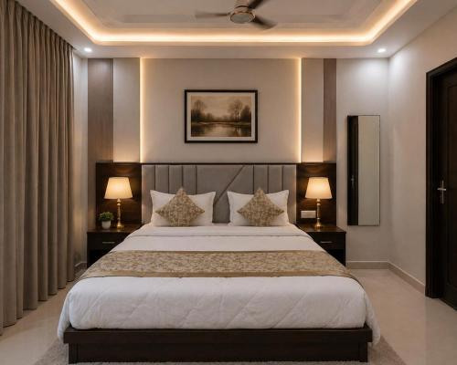 a bedroom with a large bed with two lamps at Hotel Prime Grand Residency by Rd Hotels #Most Premium Hotel in vrindavan #Lift #Parking #Fully Ac in Chhatikara