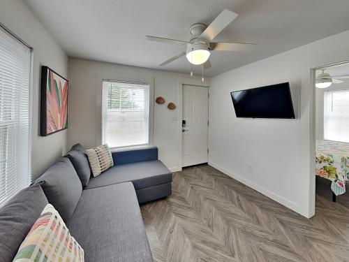 a living room with a couch and a ceiling fan at Coral Cottage in Rockport