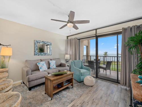 a living room with a couch and chairs and a ceiling fan at Laguna Reef #205 - La Las in Rockport