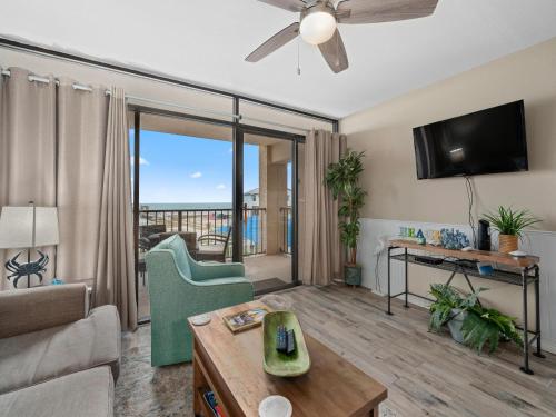 a living room with a couch and a tv at Laguna Reef #205 - La Las in Rockport