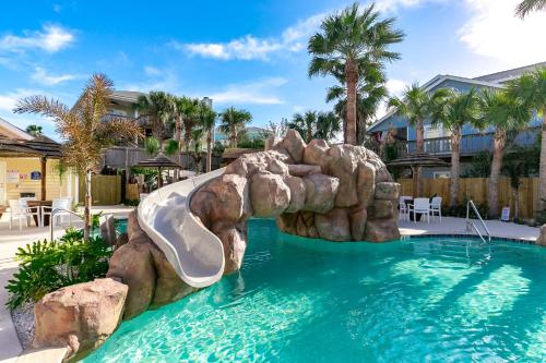a water slide in a swimming pool in a resort at Just Beachy in Port Aransas