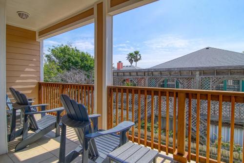 a porch with chairs and a balcony with a view at Flip Flops & Pop Tops in Port Aransas