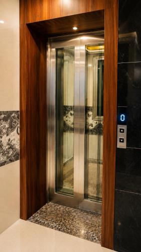 a glass door in a building with a sign on it at Hotel Prime Grand Residency by Rd Hotels #Most Premium Hotel in vrindavan #Lift #Parking #Fully Ac in Chhatikara