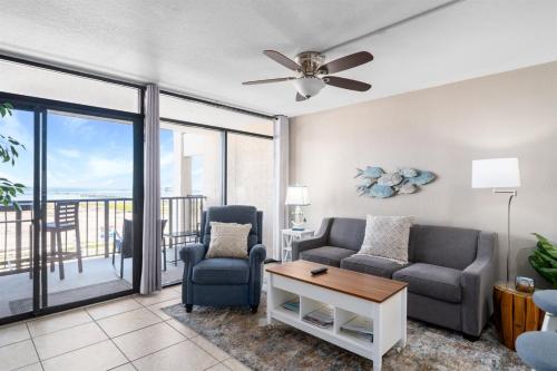 a living room with two chairs and a ceiling fan at Laguna Reef #212 - Shore 2 Please in Rockport