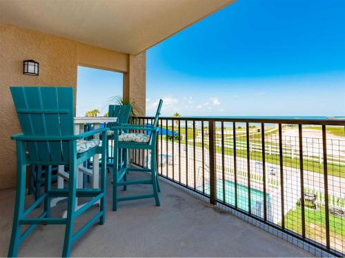two chairs and a table on a balcony with a view at Laguna Reef #213 - Four Point Lighthouse in Rockport