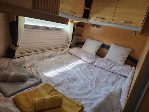 a twin bed in a small room in an rv at Sterling Leisure in Ferryhill
