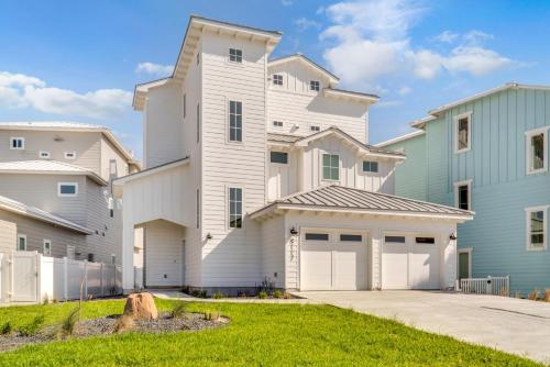 a large white house with a garage at The White House in Padre Island