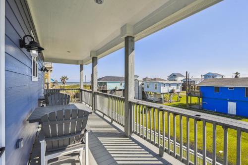 a balcony with two chairs and a view of the ocean at Sandy Cheeks Surfside in Surfside Beach