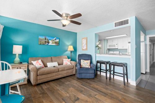 a living room with a couch and a kitchen at Laguna Reef #211 - Rod and Reel in Rockport