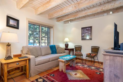 a living room with a couch and a table at Las Brisas 24 in Santa Fe