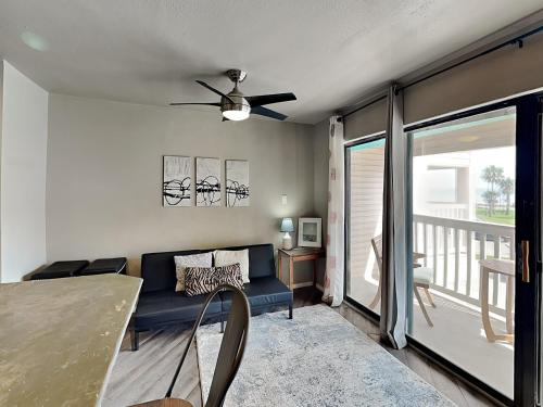 a living room with a couch and a ceiling fan at Villa Del Sol #2138 in Corpus Christi