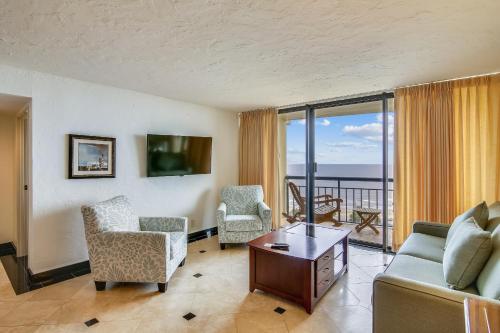 a living room with a couch and chairs and a balcony at San Luis 935-Luis Lookout in Galveston