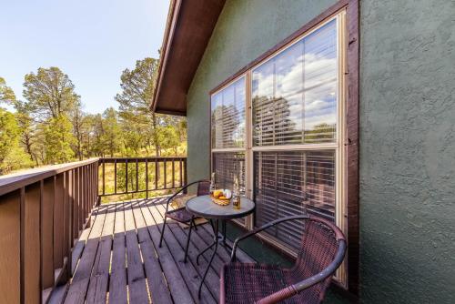 a patio with a table and chairs on a deck at Castle House in Ruidoso