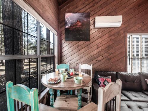 a dining room with a table and a couch at Midtown Riverfront 2 in Ruidoso