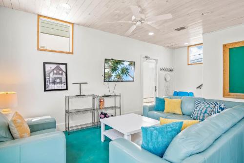 a living room with blue couches and a table at Above & Beyond in Port Aransas