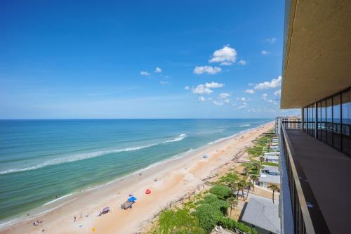 a view of the beach from a building at Oceanfront Penthouse 11b in Ormond Beach