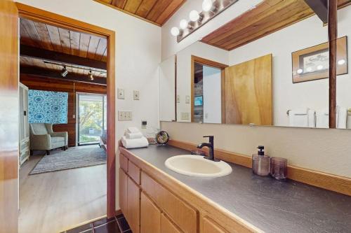 a bathroom with a sink and a mirror at Sea Side Cedar in Langley