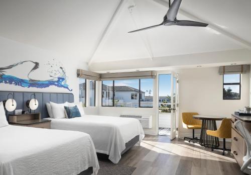 a hotel room with two beds and a table at Hotel Indigo San Diego Del Mar by IHG in San Diego