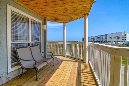 a porch with a bench on a wooden deck at Sand In Your Toes in Mustang Beach