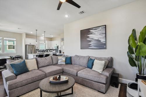a living room with a couch and a table at Sandy Cheeks Surfside in Surfside Beach