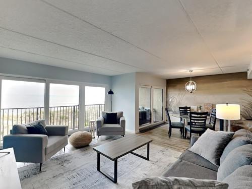 a living room with a couch and a table at Beachcomber 403 in Jacksonville Beach