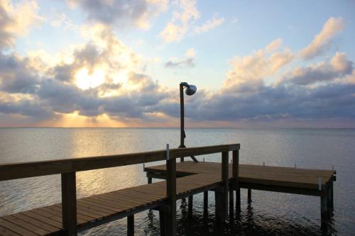 a wooden pier with a street light on the water at Frisco- Flats in Rockport