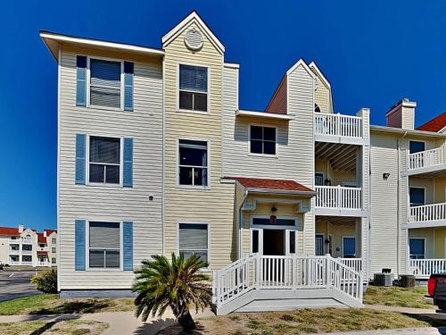 a large white house with blue accents at Toes In The Water II in Padre Island
