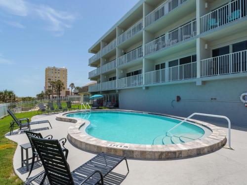 a swimming pool in front of a apartment building at Jacksonville Beachdrifter 202 - Beach View in Jacksonville Beach