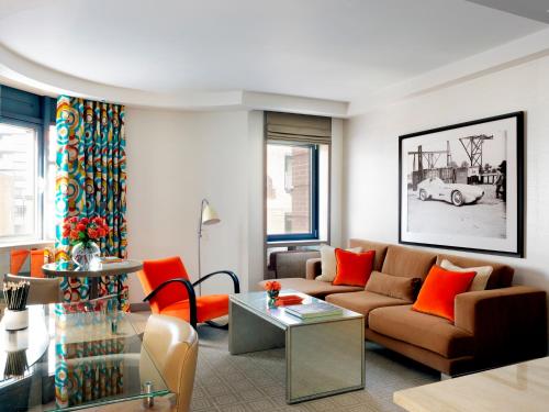 a living room with a couch and a table at The Marylebone Hotel in London