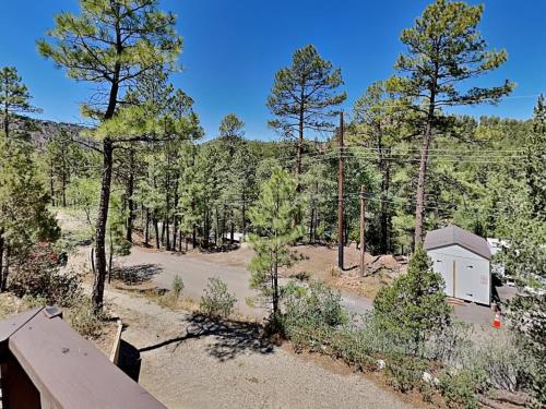 an aerial view of a cabin in the middle of a forest at Knotty Pines Cabin in Ruidoso