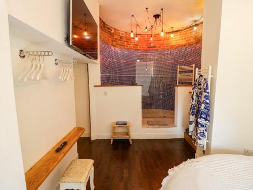 a bedroom with a shower and a bed in a room at Lower Tundridge Cottage in Suckley