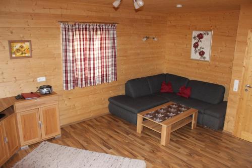 a living room with a couch and a table at Feriendorf am Hahnenkamm in Reutte