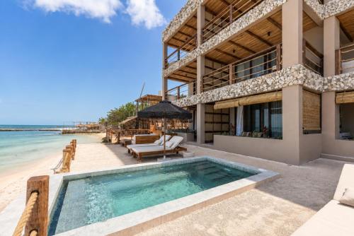 a villa on the beach with a swimming pool at Luxury Villas By Awa Holbox - Beachfront in Holbox Island