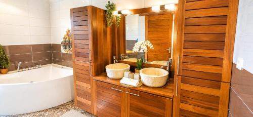 a bathroom with two sinks and a bath tub at lilie97418 in La Plaine des Cafres