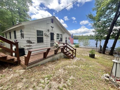 a white house with a porch and a fence at LITTLE PICK LIMIT 6 villa in Hillside