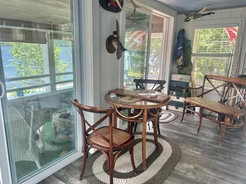 a room with a table and chairs and a window at LITTLE PICK LIMIT 6 villa in Hillside