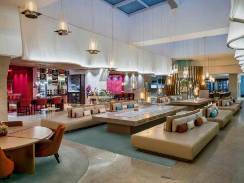 a lobby with couches and tables and a restaurant at Novotel Istanbul Bosphorus Hotel in Istanbul